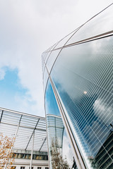 Reflection of the sky on a skyscraper. View of skyscrapers from below