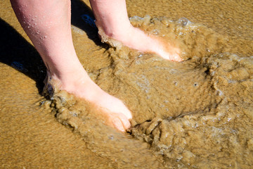 Feet in the sand and surf at Virginia Beach