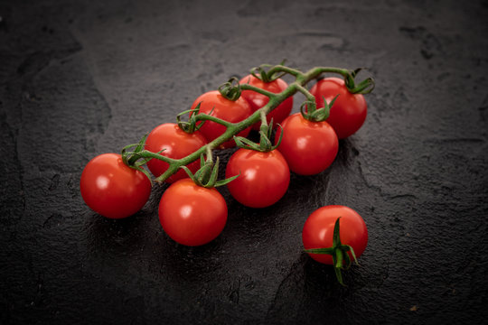 Fresh Cherry Tomatoes On A Black Background