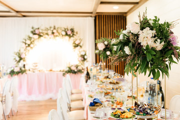The concept of decor for weddings and holidays, floral arrangements on the table of fresh flowers.  The Presidium of the newlyweds