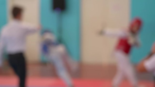 Taekwondo sport competitions between youth. Blurry video footage of young boys in sparring.