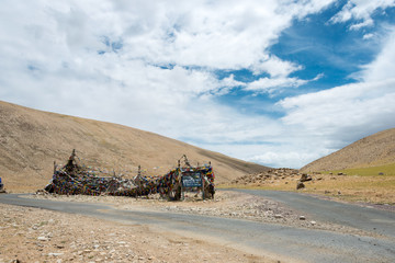 Fototapeta premium Ladakh, India - Jul 12 2019 - Tibetan prayer flag at Kiagar La Pass in Ladakh, Jammu and Kashmir, India. Kiagar La is situated at an altitude of around 4843m above the sea level.