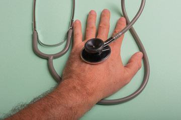 Stethoscope with gray rubber, on a hand of a man