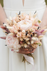 Bridal morning details. Wedding beautiful bouquet in the hands of the bride, selectoin focus