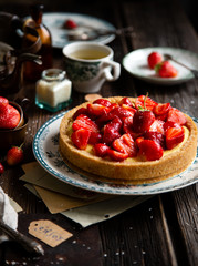 Homemade delicious strawberry tart or pie with sweet glazed berries on top