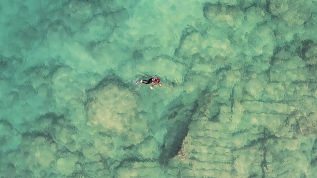 Scuba divers explore shipwreck near Israel shore. aerial drone view