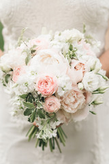 Bridal morning details. Wedding beautiful bouquet in the hands of the bride, selectoin focus