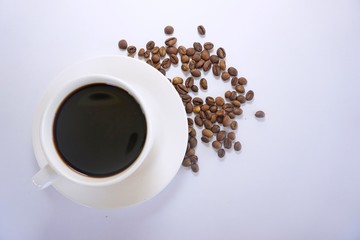 cup of coffee with beans on white background