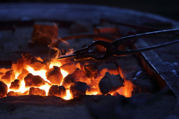 Hot coals in a furnace for heating metal for manual forging in a blacksmith workshop