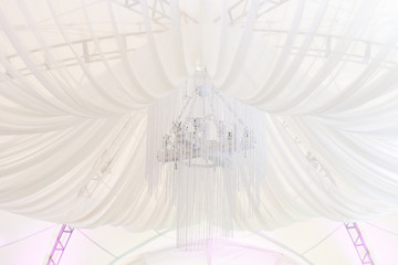The concept of decoration for wedding and celebration, beautifully decorated ceiling with white fabrics in the tent or the restaurant