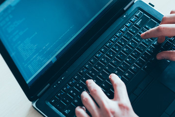 QA automation testing. Software development. IT engineer writing code on laptop.