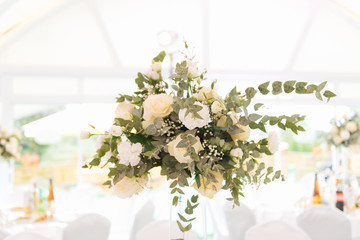 Beautiful decor for the holiday and wedding, floral arrangements on the table of fresh flowers. The concept of the wedding decor