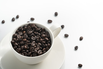 bottom left top view black coffee bean in white cup with white background