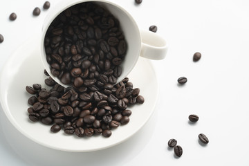 left top view black coffee bean in white cup with white background
