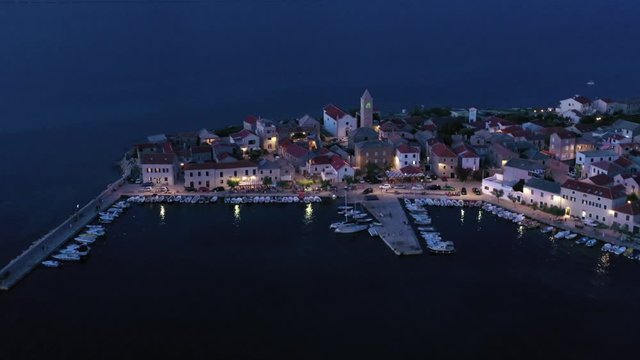 Serene Vinjerac, Croatia lit up at dusk, long slow advancing aerial