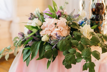 The concept of decor for weddings and holidays, floral arrangements on the table of fresh flowers.  The Presidium of the newlyweds