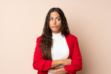 Young woman over isolated background thinking an idea