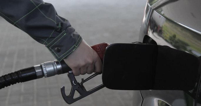 Gas nozzle is getting taken out from car's fuel tank