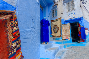 Traditional carpets on the blue Chefchaouen street. Morocco