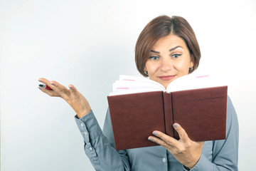 business girl with a red pen and notebook in hands on a white background