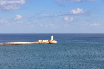 lighthouse in Valette Malta in the mediterranean sea and cruise ship