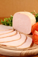 Sliced chicken ham with vegetables.