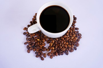 cup of coffee with beans on white background