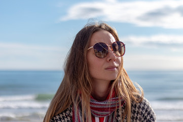 Pretty blonde girl on the beach with red jersey on the beaches of Barcelona