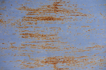old metal background in blue with paint that is peeling and rusty