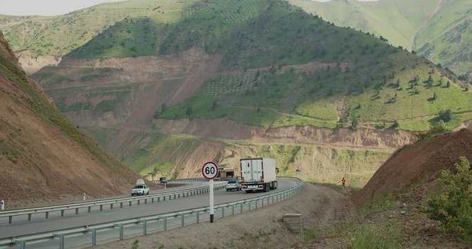 Cars moving on the mountain pass Kamchik in Uzbekistan. To Fergana Valley, Central Asia.