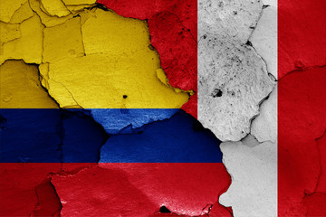 flags of Colombia and Peru painted on cracked wall