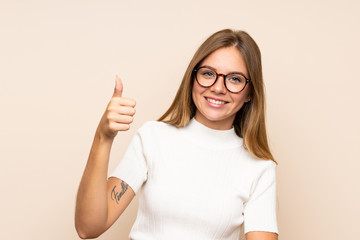 Young blonde woman over isolated background with glasses