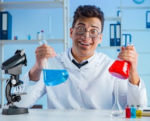 Funny mad chemist working in a laboratory