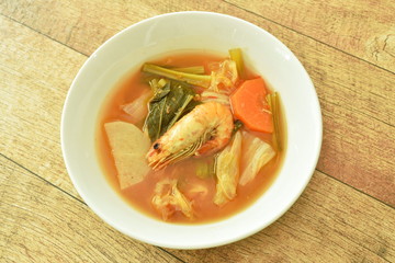 boiled mixed vegetable topping shrimp Thai spicy soup on bowl