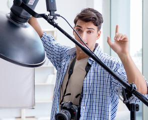 Young photographer working in photo studio
