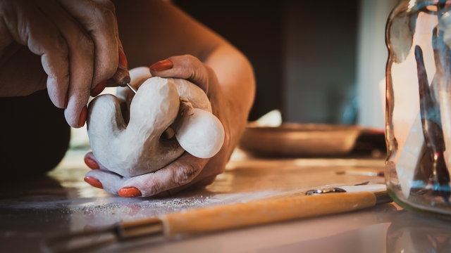 creating sculpture in shady art studio
