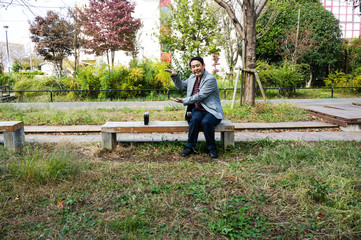 man sitting on a bench in the park