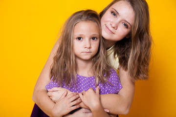 Portrait of two fashionable beautiful girls in dresses