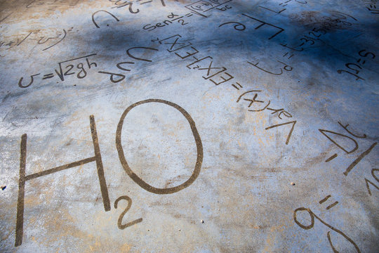 Chemical equations on a stone pavement. H2O. - Powered by Adobe