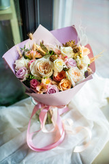 bouquet of roses flowers. Bouquet of natural fresh roses, tulips, anemones, peonies, buttercups, matiola, daffodil, cloves, eucalyptus. Bouquet of flowers decorated with a composition of flowers