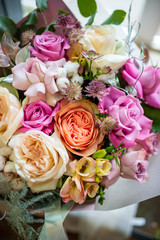 bouquet of roses flowers. Bouquet of natural fresh roses, tulips, anemones, peonies, buttercups, matiola, daffodil, cloves, eucalyptus. Bouquet of flowers decorated with a composition of flowers