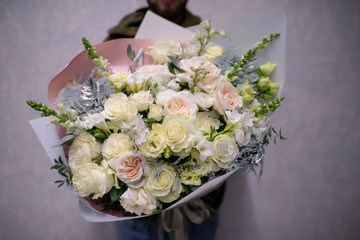 bouquet of white roses. Bouquet of natural fresh roses, tulips, anemones, peonies, buttercups, matiola, daffodil, cloves, eucalyptus. Bouquet of flowers decorated with a composition of flowers
