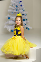The girl at the Christmas tree.Beautiful little girl near the Ch