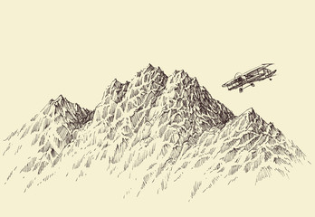 A flight over the mountains. Plane flying over alpine landscape © Danussa