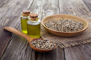 Hemp seeds and hemp oil on wooden background