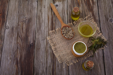 hemp oil, powder, seeds on wooden table