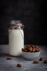 Almond milk with almond on a wooden table