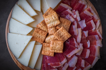 Wood plate with freshly ham, cheese and roasted bread. Healthy food. Spanish food.