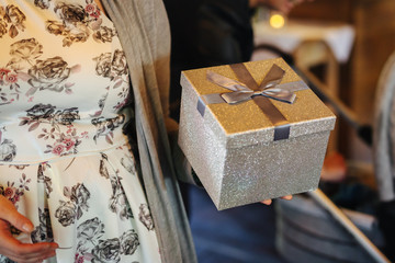 woman holding a gift in her hand