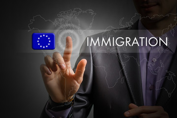 European Union immigration concept. Man pressing virtual button with flag icon